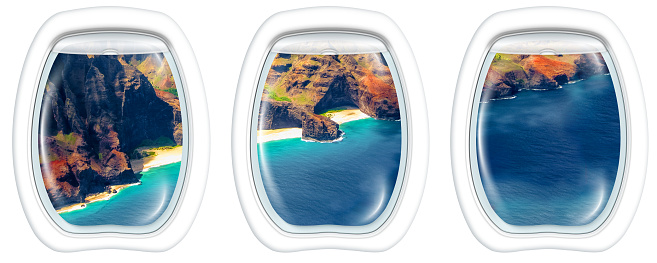 Three plane windows on Na Pali coast, Kauai, Hawaii, United States, from a plane on the porthole windows. Copy space.