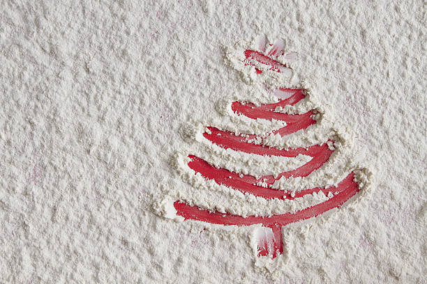 istock Christmas tree on flour background. White flour looks like snow. 629864174