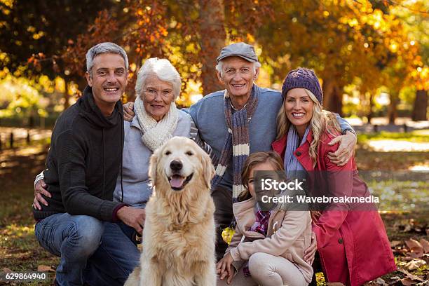 Multigeneration Family With Dog At Park Stock Photo - Download Image Now - Family, Multi-Generation Family, Portrait