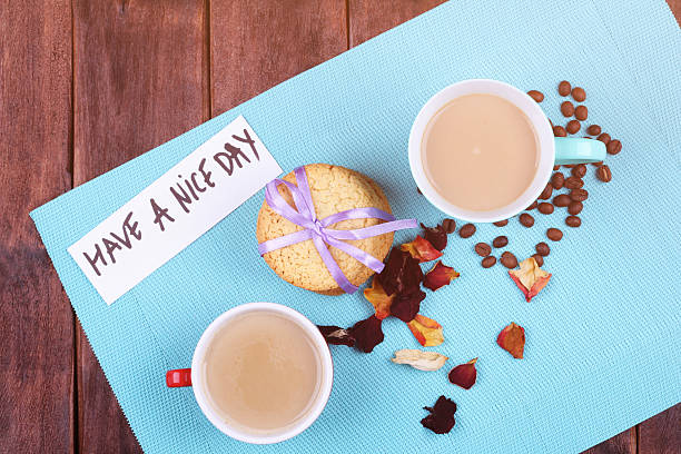 genießen sie einen schönen tag  - coffee bean coffee flower ribbon stock-fotos und bilder