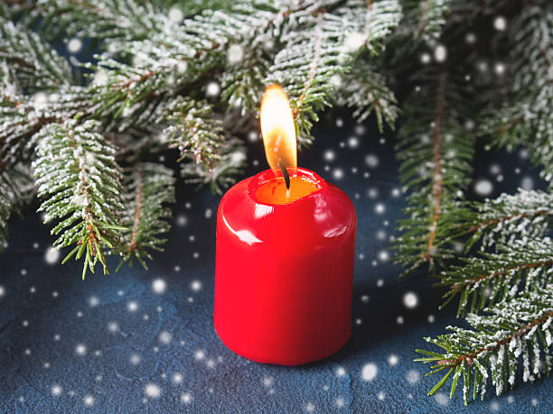 istock Dark christmas background with red candle and snow 629865558