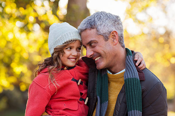 istock Happy father carrying daughter at park 629865834