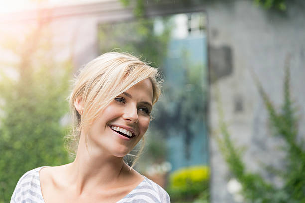 istock Cheerful young woman looking away at yard 629866322