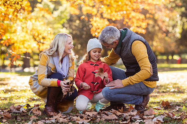 istock Happy family at park during autumn 629868166