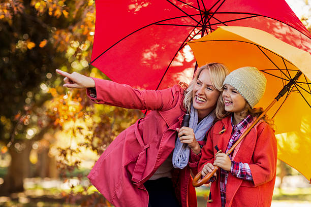istock Happy woman pointing while standing by daughter 629868392