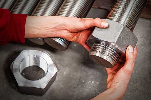 Worker is checking machine parts in workshop