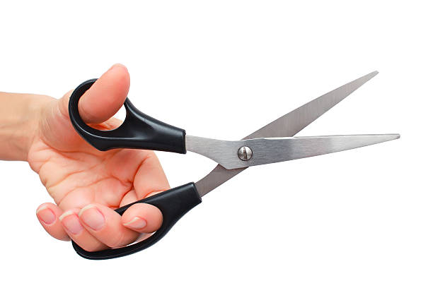 Hand is holding scissors isolated on a white background stock photo