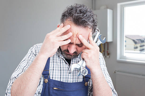 istock Sad male fitter having headache 629869978