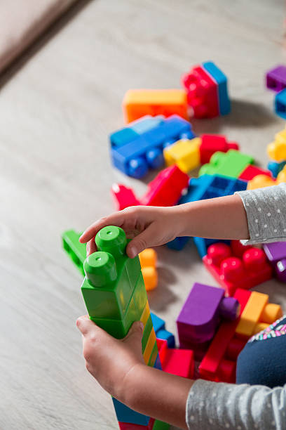 istock Close up of child hand playing with plastic construction 629941010
