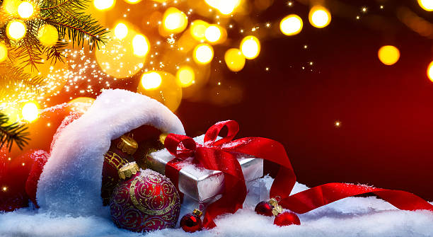 istock Christmas gift box and holidays lights on red background 629941518