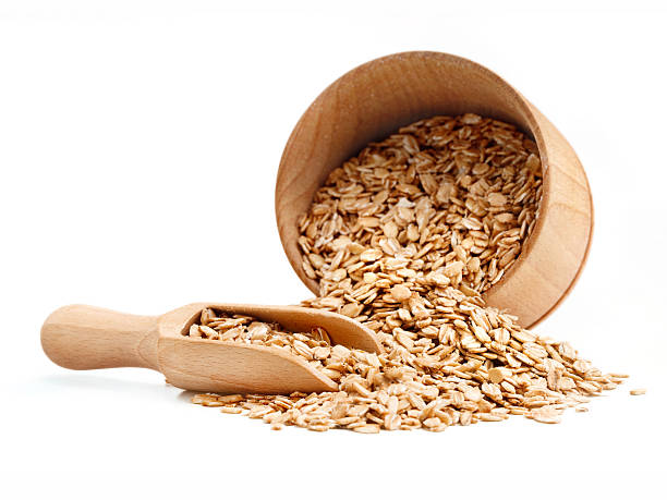 istock Oats scattered from wooden bowl 629942490