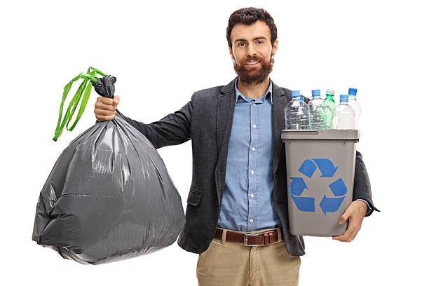 istock Bearded guy holding a garbage bag and a recycling bin 629951160