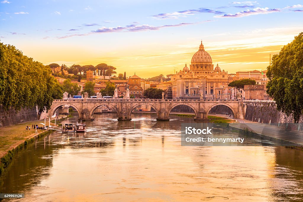 Rome at Sunset Rome at Sunset with San Pietro basilica, Sant'Angelo bridge and Tevere river in Roma, Italy Rome - Italy Stock Photo