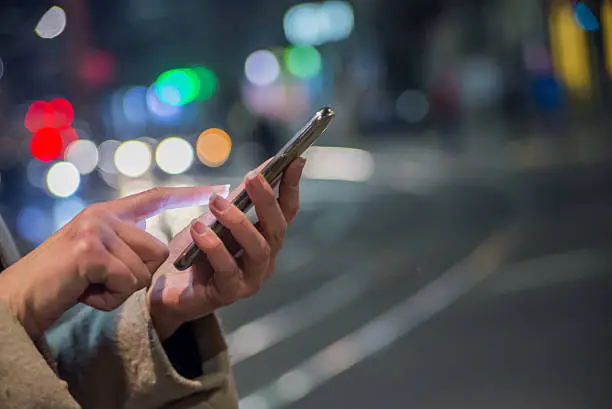 Photo of Girl Enjoying Winter Holiday Season, Using phone, social networking