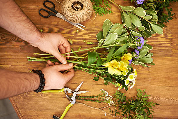 istock Male hands arranging fresh flowers 629951684