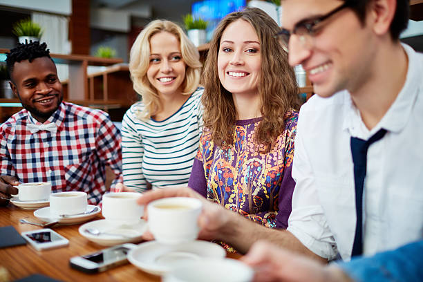 istock Positive young friends gathering in cafe 629952310