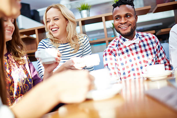 istock Young multi-ethnic friends having fun in cafe 629952370