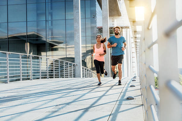 istock Young female and male jogging 629953334