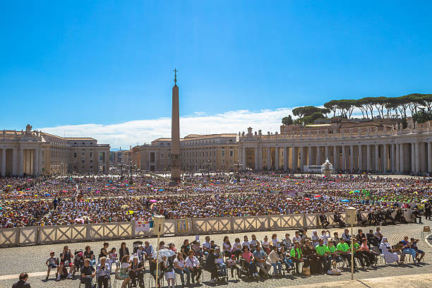 Rome, Italy - June 18, 2016: paromic view of people sitting while you listen to Pope Francesco speaking for jubilee event in St. Peter's Square, Vatican.