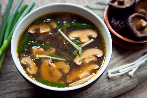Shiitake mushrooms, enoki and spring onions  Chinese broth  soup.