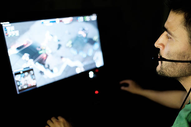 istock Man playing video game in dark room 629961270