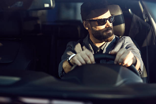 istock Attractive elegant driver in good car 629961400