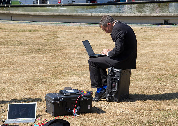 Reporter with Laptop The Hague, The Netherlands - June 3, 2011: Sky News reporter with laptop at the Jugoslavia Tribunal in The Hague, covering the trial of ex-general Mladic in The Hague, The Netherlands on June 3, 2011 sky news stock pictures, royalty-free photos & images