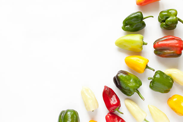 istock Creative arrangement of colorful bell peppers on white 629962004