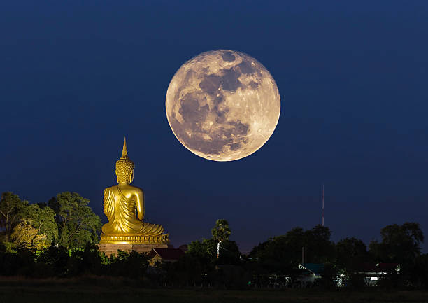 istock big buddha statue in the night with super full moon 629962998