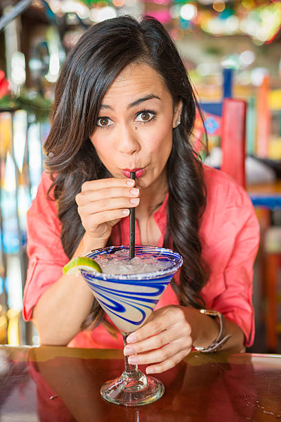 Young Hispanic Women At Mexican Restuarant Drinking Margarita