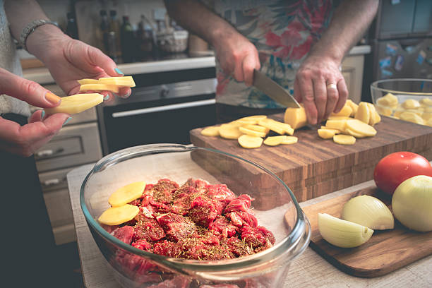 Family cooking baked meat with potatoes  and vegetable horizontal