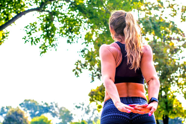 istock Young woman doing stretching exercise at sunset 629964914