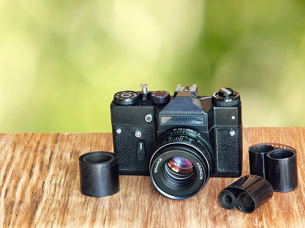 istock Old retro photo camera and film negative strip. 629965066