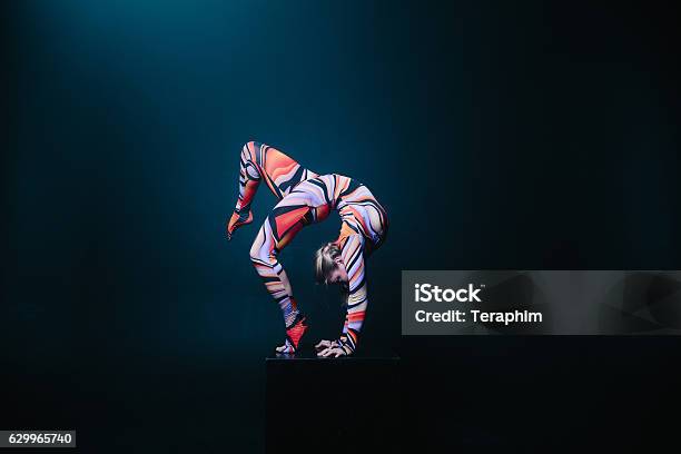 Flexible Circus Acrobat Doing Equilibre Balance Handstand On A Cube Stock Photo - Download Image Now
