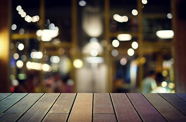 istock image of wooden table in front of abstract blurred background 629967014