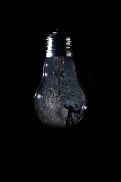 milky way galaxy inside of light bulb on dark background - milky way galaxy space star imagens e fotografias de stock