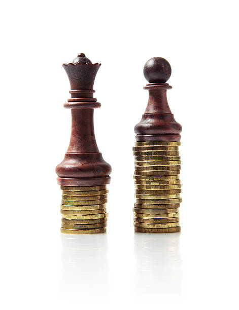 Image of chess pieces standing on stacks of coins isolated on white Image of brown chess pieces standing on stacks of coins isolated on white background. Money investment strategy and earnings concept image. equity vs equality stock pictures, royalty-free photos & images