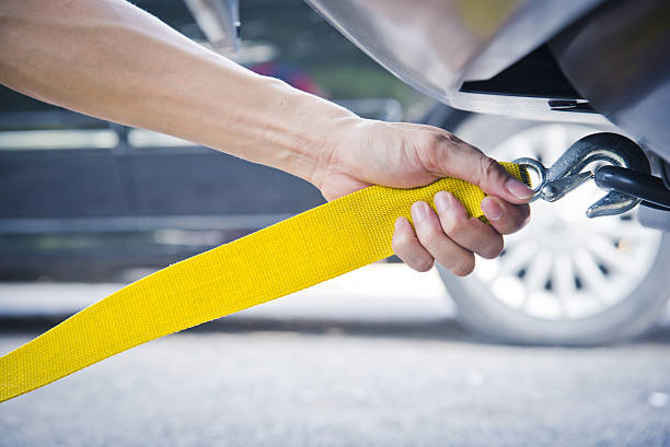 istock hands towing car with towing rope 629987604