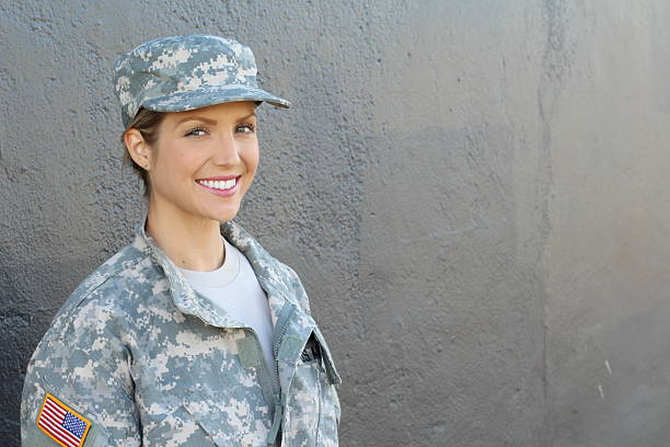 istock Smiling female soldier standing with copy space 629987938