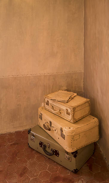 istock Vintage suitcases on a worn floor, vertical image 629993886