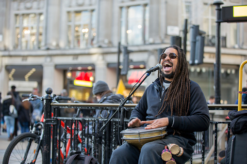Reggae singer with jembe at urban street