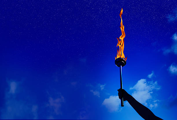 flaming torch of success - flaming torch fire flame sport torch imagens e fotografias de stock