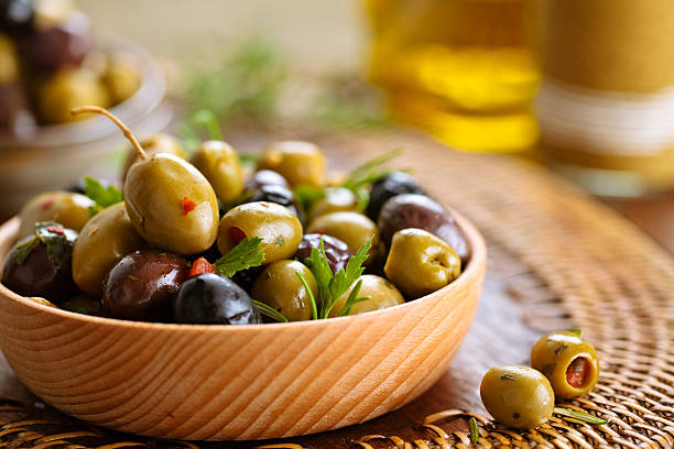 marinated olives with herbs. - olive green olive stuffed food imagens e fotografias de stock