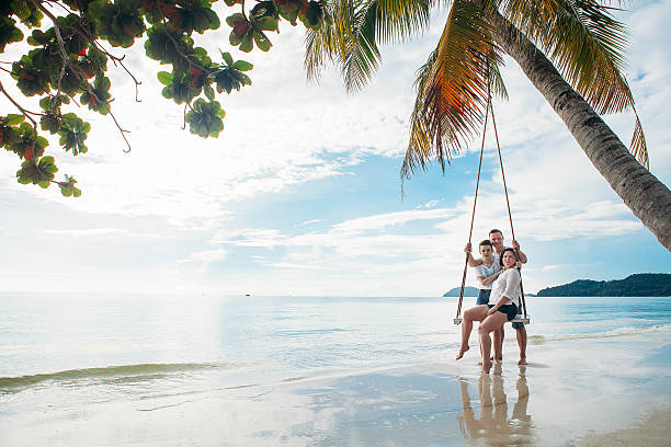 istock Family sit on Swing tropical beach 630019776