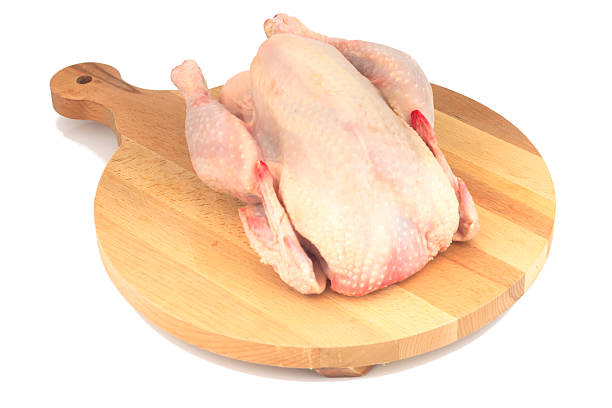 istock Raw organic chicken on wood cutting board 630020792