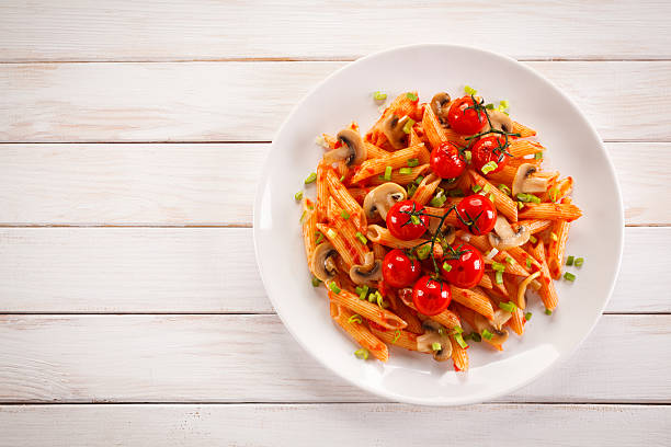 Penne with pesto sauce and vegetables