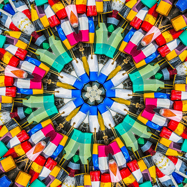 An abstract kalaidoscope effect of a close up of a    of  colorful old wooden lobster buoys hanging on a wall.
