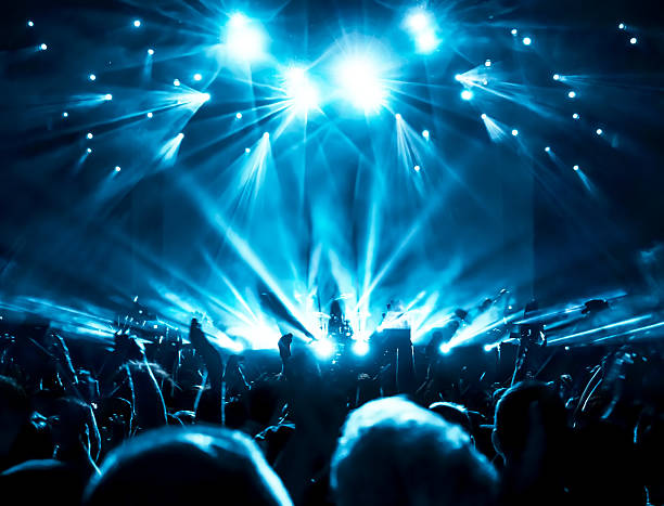 Concert Crowd Silhouettes of crowd at a rock concert stage light stock pictures, royalty-free photos & images