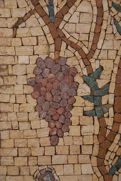 Mosaic of a bunch of grapes in an ancient tile setting