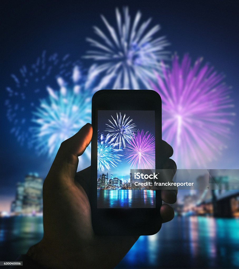 smartphone take a pic of the nyc celebration Firework Display Stock Photo